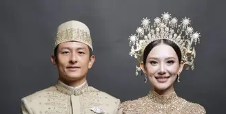 Gaya busana resepsi Athina Papadimitriou dan Rio Haryanto begitu menawan. Keduanya mengenakan baju adat peranakan Melayu yang begitu megah. [Foto: Instagram/ The Bridestory]